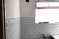 Bathroom gut and hack off all old tiles and build material. Render internal walls, dot n dab Moisture plasterboard to wall area. Re-plaster all walls and ceiling areas.