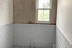 Bathroom gut and hack off all old tiles and build material. Render internal walls, dot n dab Moisture plasterboard to wall area. Re-plaster all walls and ceiling areas.